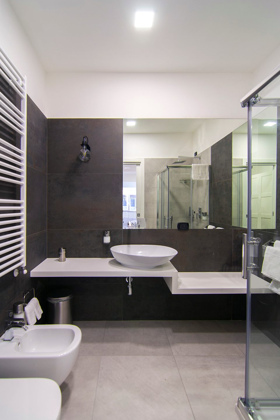 Private bathroom with a washbasin, mirror and shower.